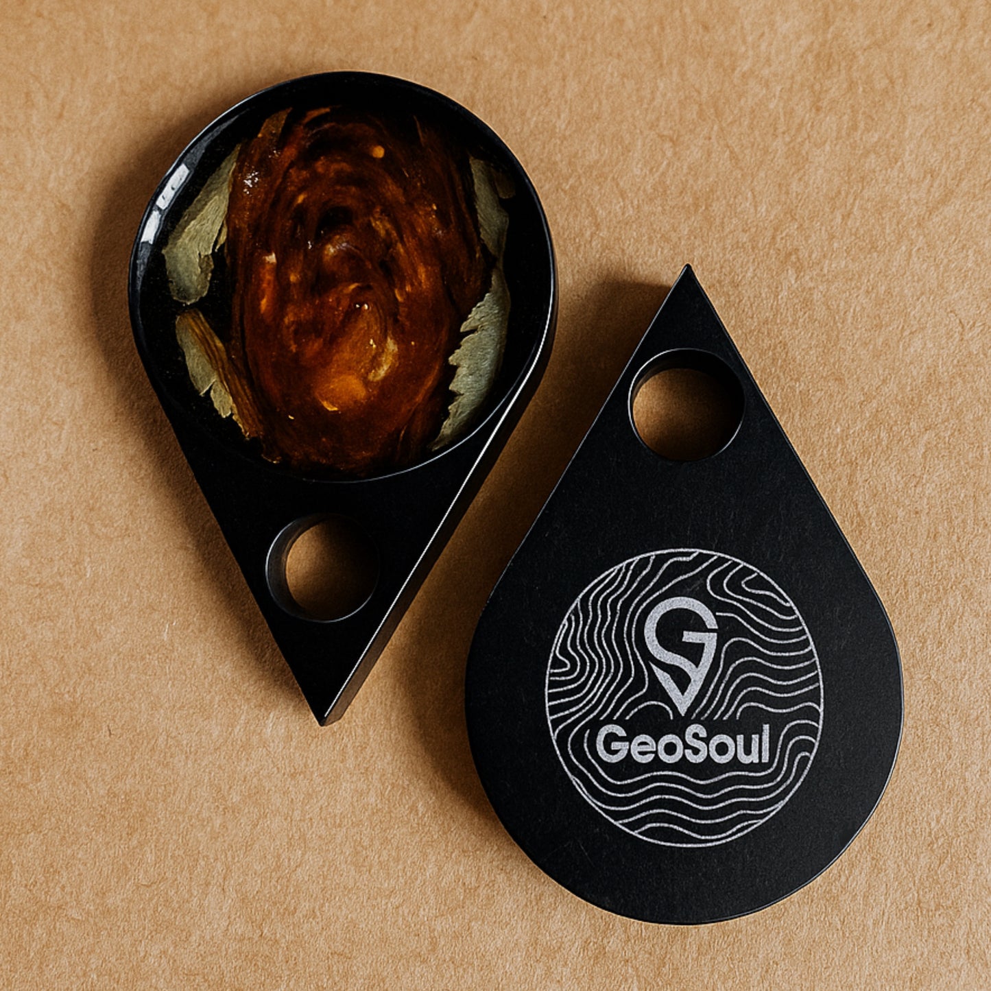 GeoSoul tokens of love on a brown background showing anodized aluminum tokens with GeoSoul logo and keepsake flower embedded in epoxy for memorial, bereavement, wedding, anniversary gift.